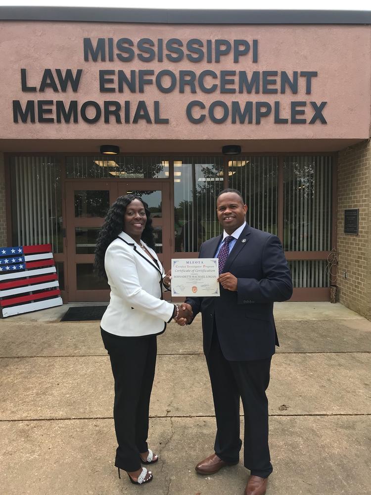 Sheriff K.C. Hamp congratulates Captain Bernadette Logan