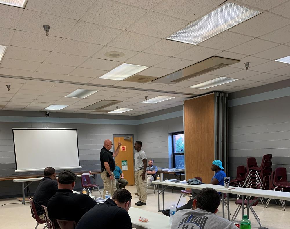 Instructor speaking to a student.