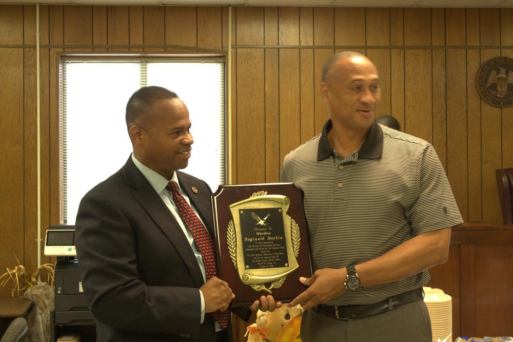 Sheriff Hamp handing off the plaque.