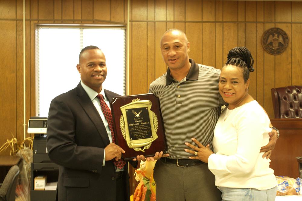 Sheriff Hamp holding a plaque to give away.