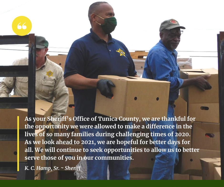 Sheriff Hamp distributing boxes of food.