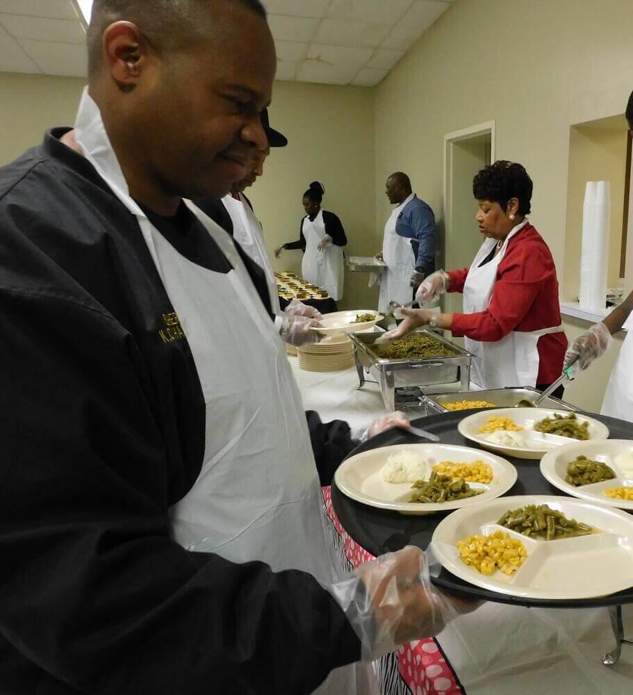 Sheriff Hamp holding a tray of food.