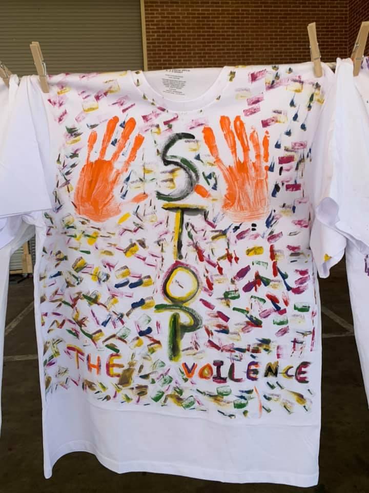 t shirt hands from Clothesline Project raising awareness to STOP domestic violence.