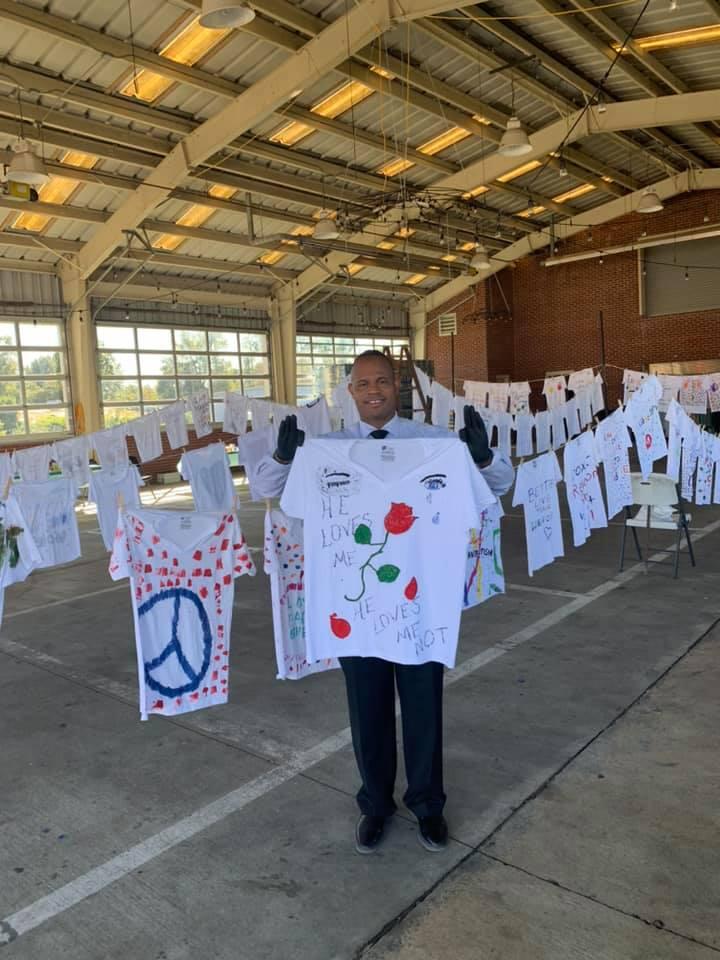 Sheriff shows off shirt he painted promoting violence to end.