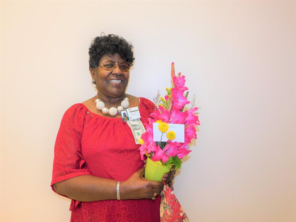 Nellie Harris poses for photo with bouquet of flowers on her birthday.